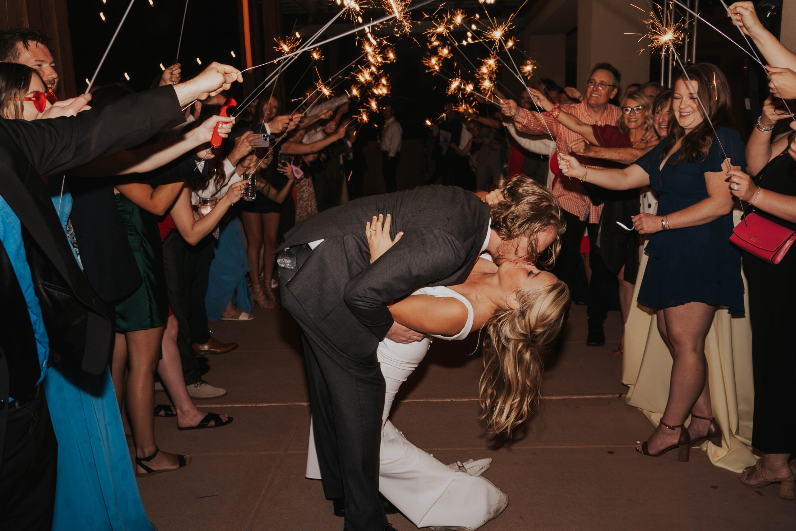 Bride and Groom Kiss During Sparkler Exit