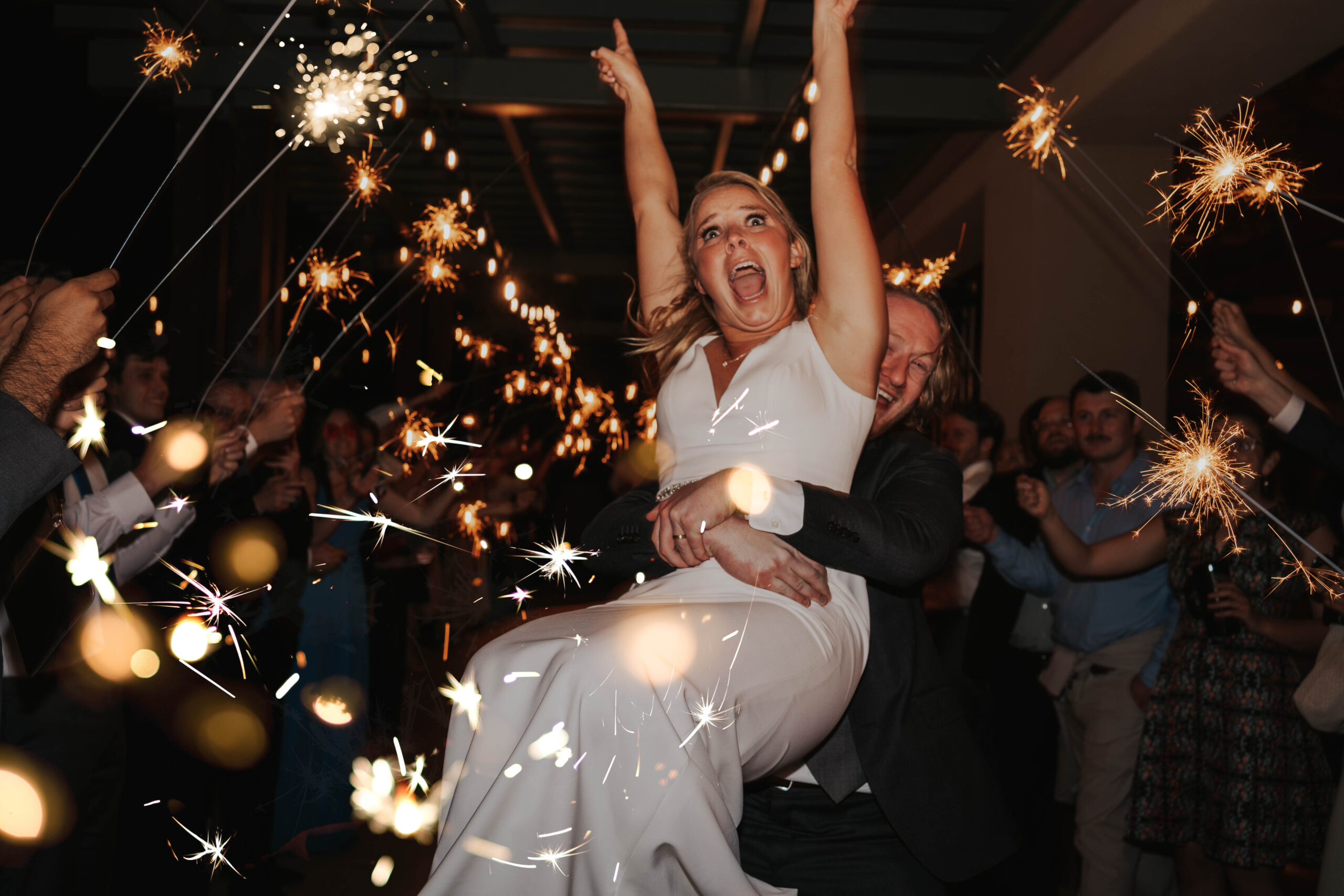 Bride Celebrates During Sparkler Exit Boulder Colorado Wedding
