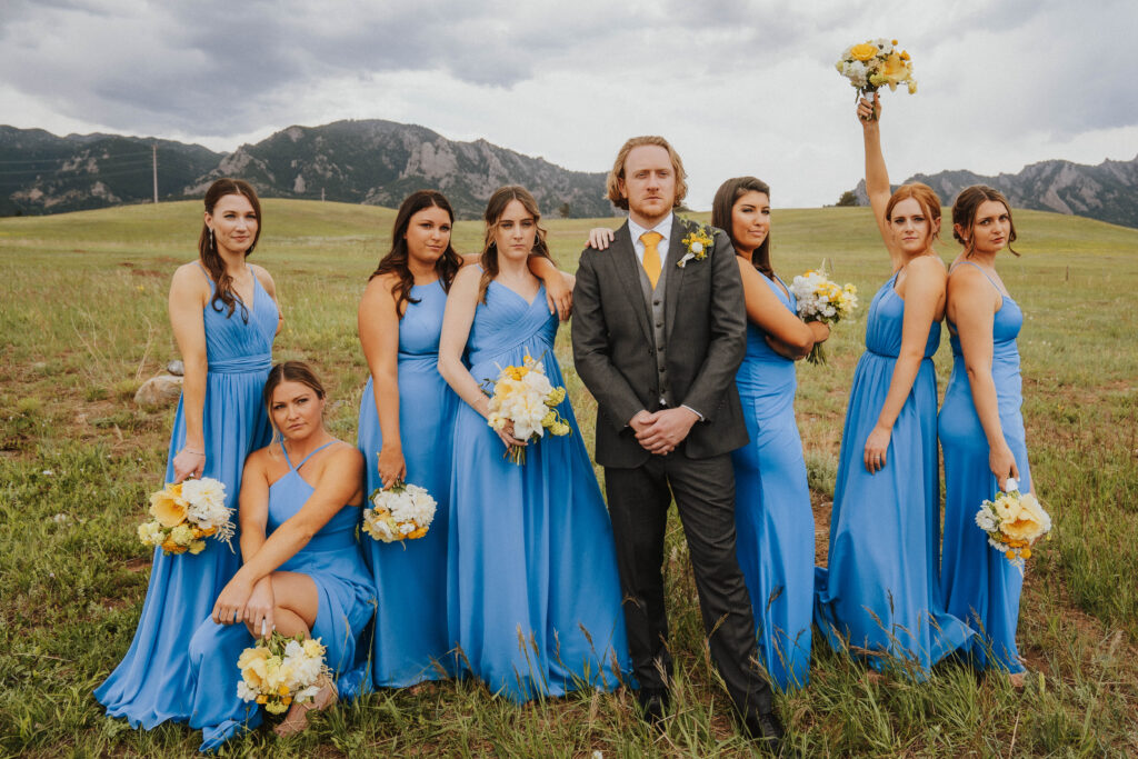 Groom Poses With Bridesmaids