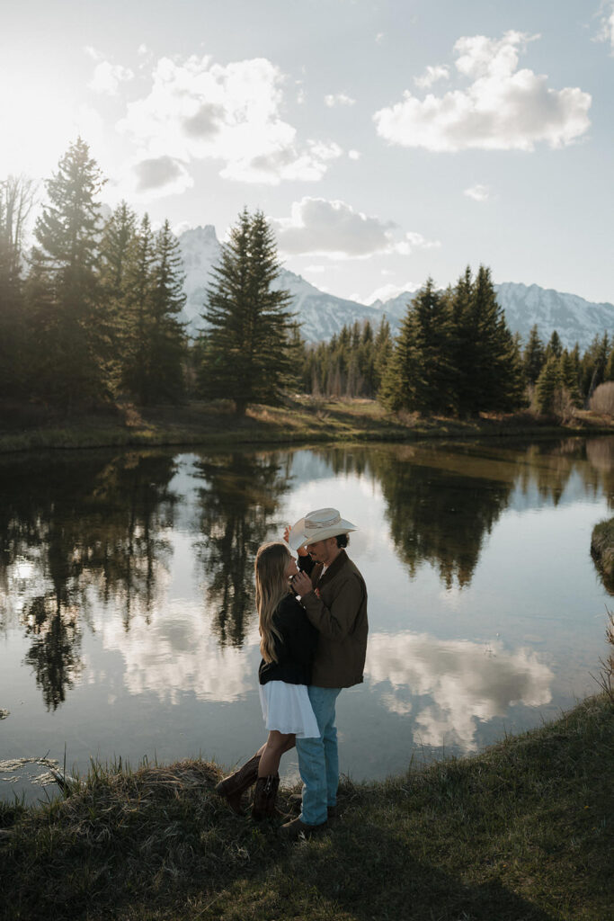 a western couple taking engagement photos in grand teton national park with a jackson hole photographer near me 